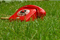picture of red phone in grass field on a law firm call intake post for