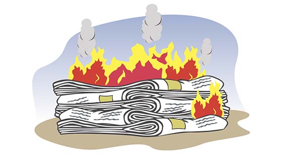 stack of newspaper on fire